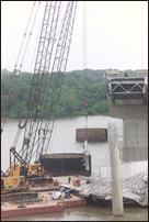 Barge Removing Beam Away from Bridge