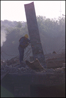 Worker Cutting Steel from Barge Early Morning