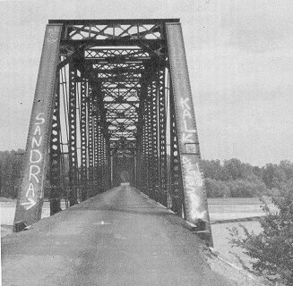 The strength, height, and narrowness of Bridge 63D3342E1446000, a three span camelback through truss, show its origins as a railroad structure.  Pin-connected and measuring 785 feet, it stands over the South Canadian River near Wanette.