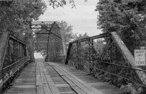 Bridge 53E0135N4180003 exemplifies the mixed truss type bridge of Oklahoma.  A Pratt pony truss stands on each end of a Parker through truss.  Built in 1909 by Canton Bridge Company, it spans the Verdigris River north of Oologah Wildlife Area in Nowata County.