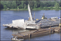 Barge Moving Beam Away from Bridge