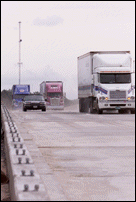 First Trucks Cross Bridge Heading Westbound