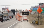Photo showing lane drop construction sineage.