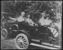 1910 photo of Suggs and Gilbert riding in old car