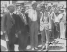 Wiley Post standing between oilman F.C. Hall, Gov. William “Alfalfa Bill” Murray and Navigator Harold Gatty.