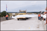 A truck breaks through the ribbon at the Webbers Falls bridge re-opening.  A section of the bridge collapsed after it was stuck by a barge in May 2002